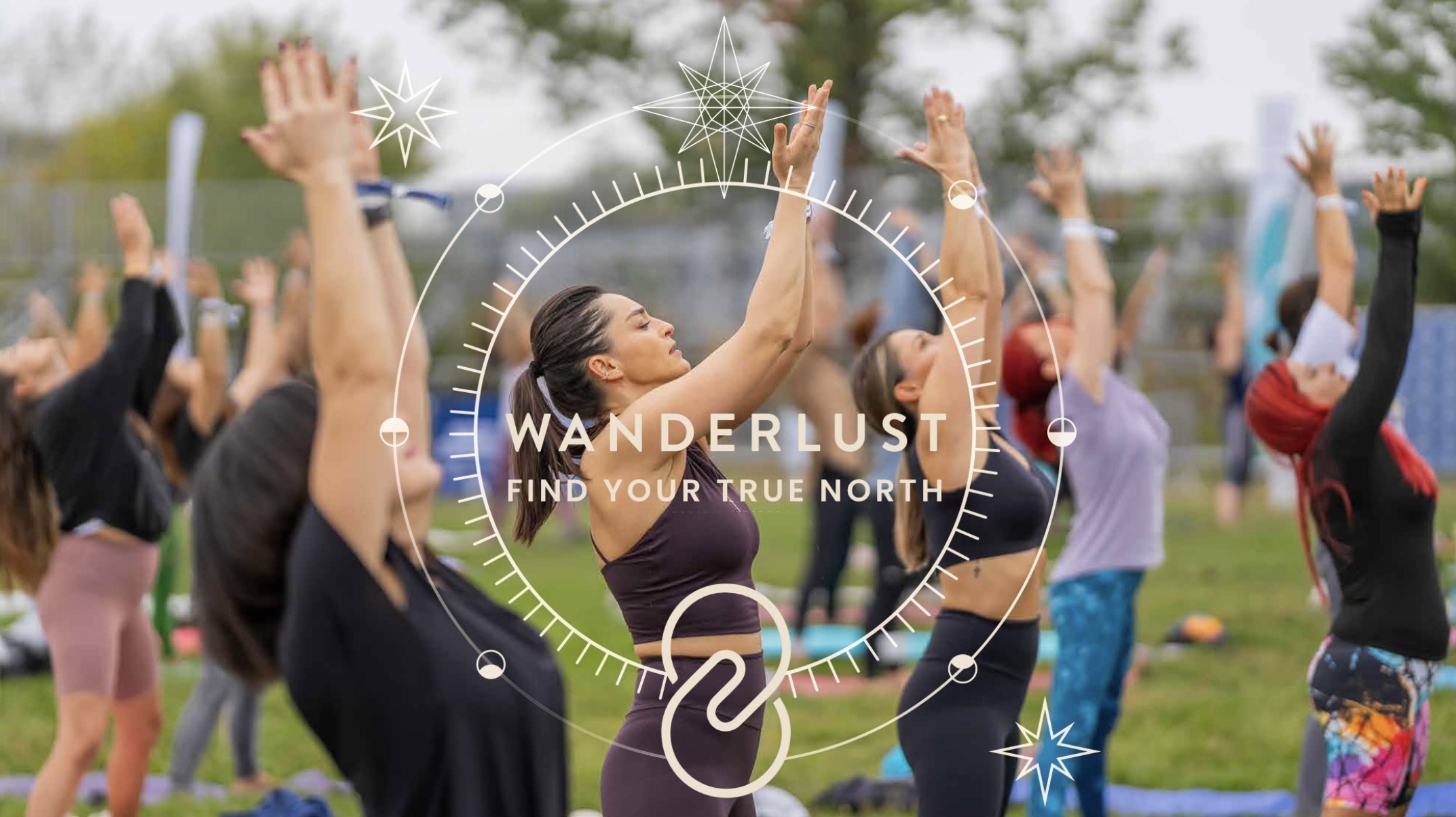 Wanderlust Festival - Group yoga practice outdoors with 'Find Your True North' branding